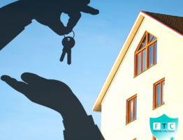 shadow of a hand with keys and a house